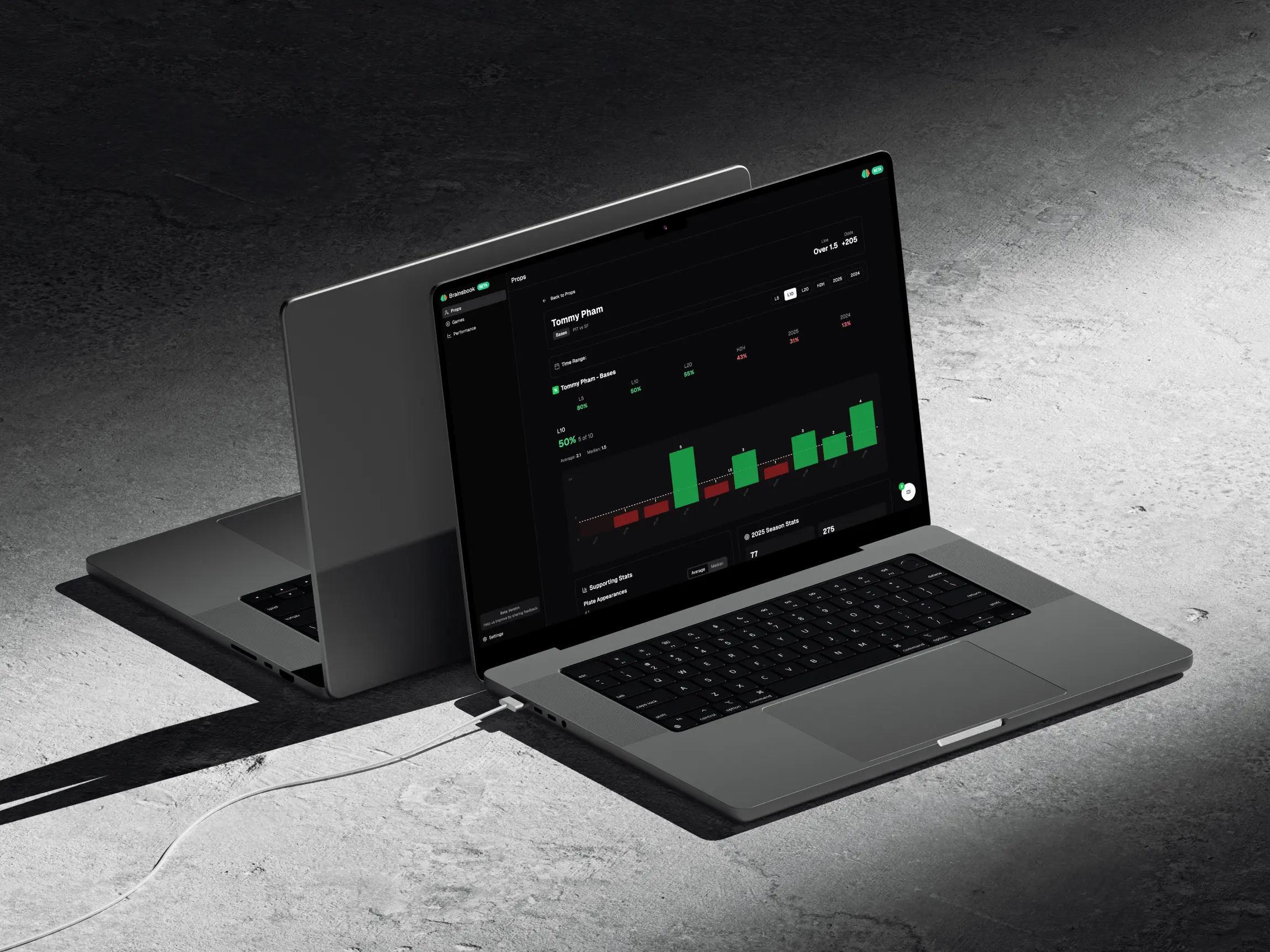 Brainsbook landing page on Macbook laptop that is sitting on concrete
